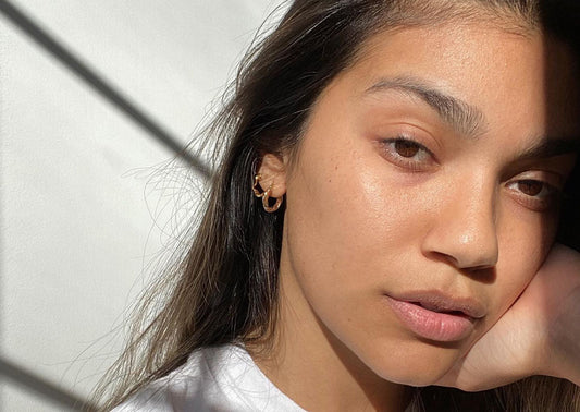 woman with hand on her face