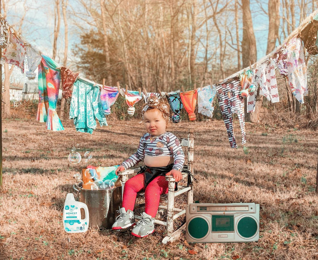 girl sitting in front of clothes line