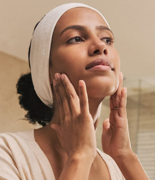 Woman with hands on jawline