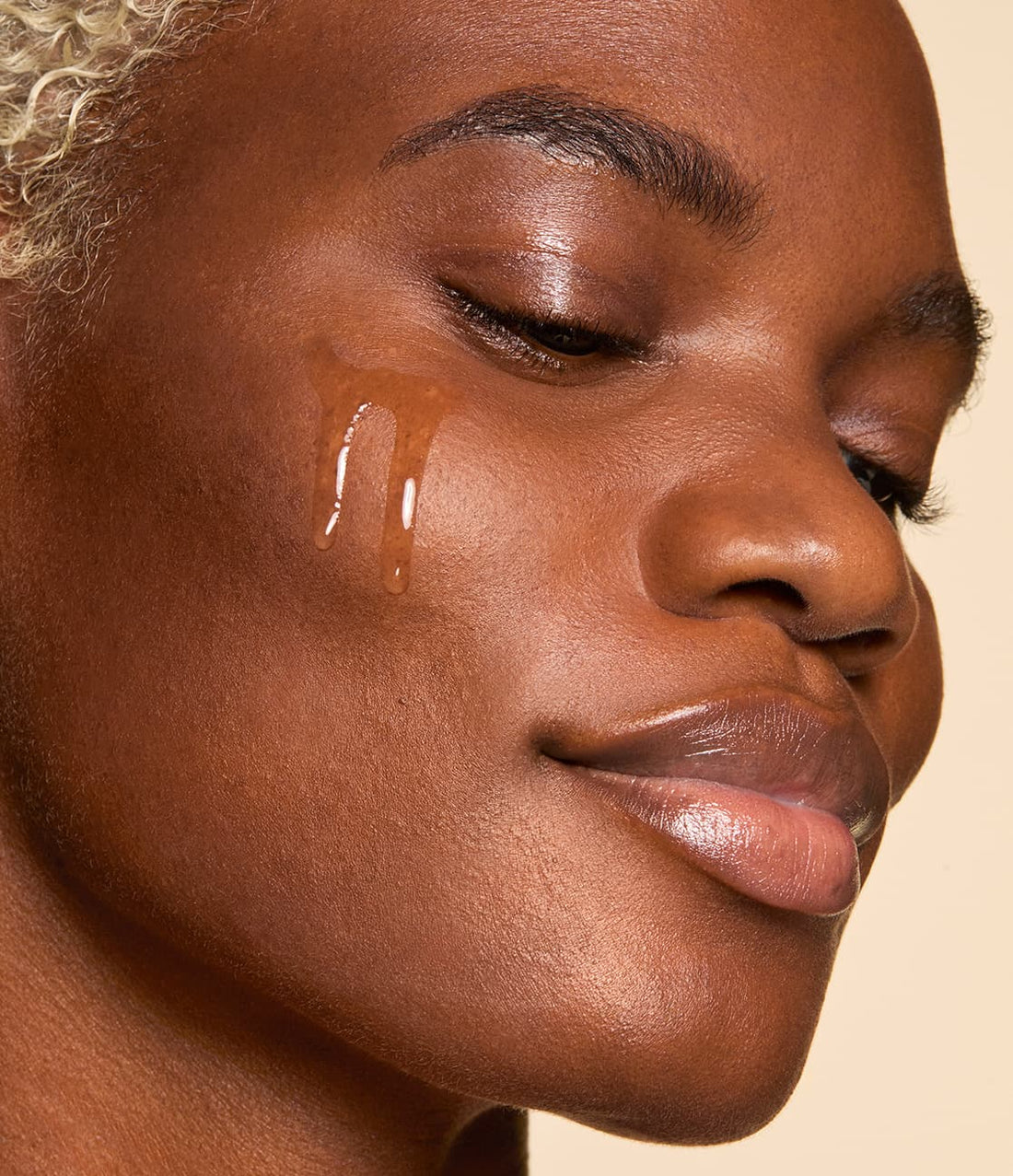 Woman with serum on cheek