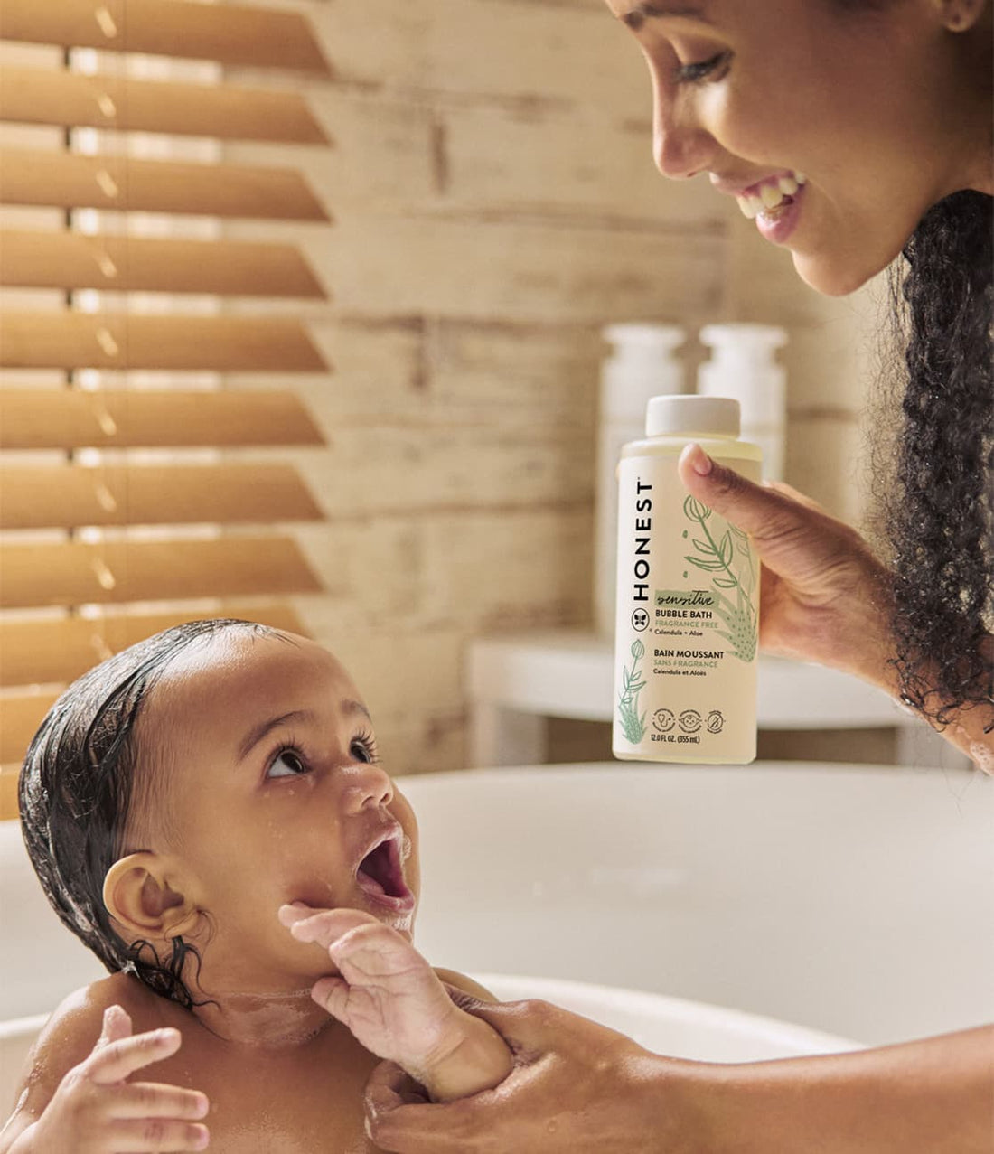 Woman bathing toddler with Honest Sensitive Bubble Bath