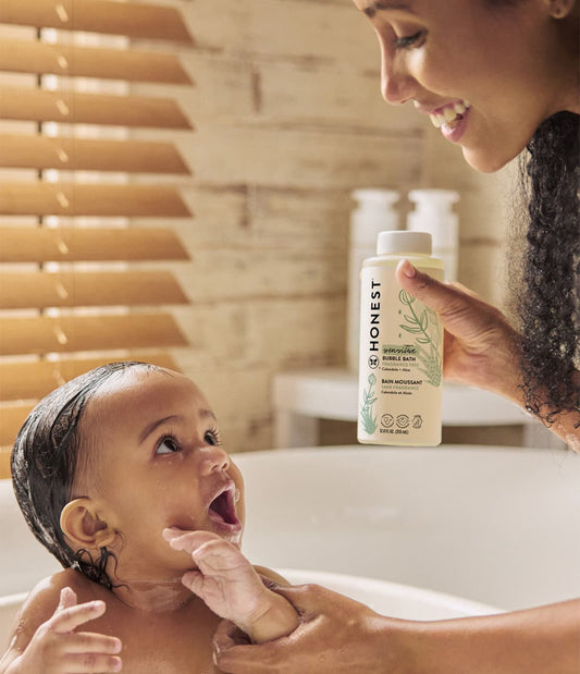 Woman bathing toddler with Honest Sensitive Bubble Bath
