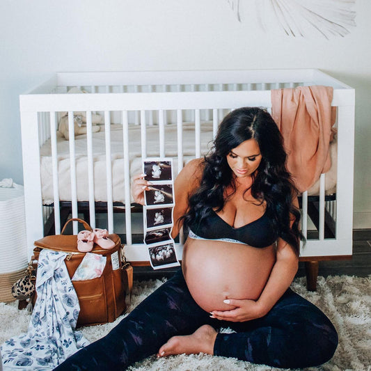 Pregnant mama holding ultrasound photos