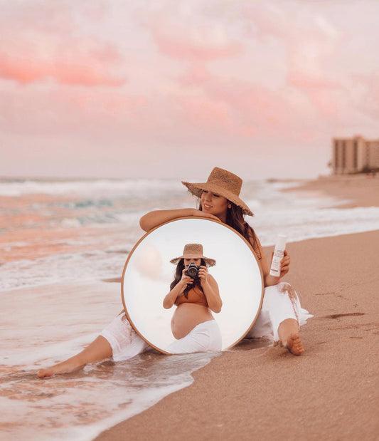 Pregnant woman holding sweet curves lotion