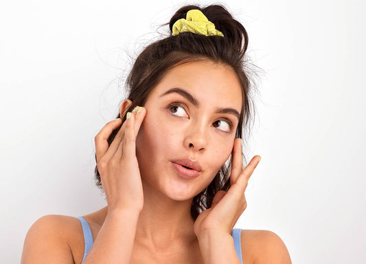 model holding her cheeks