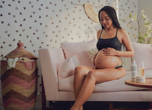 pregnant mama touching her belly in a home setting