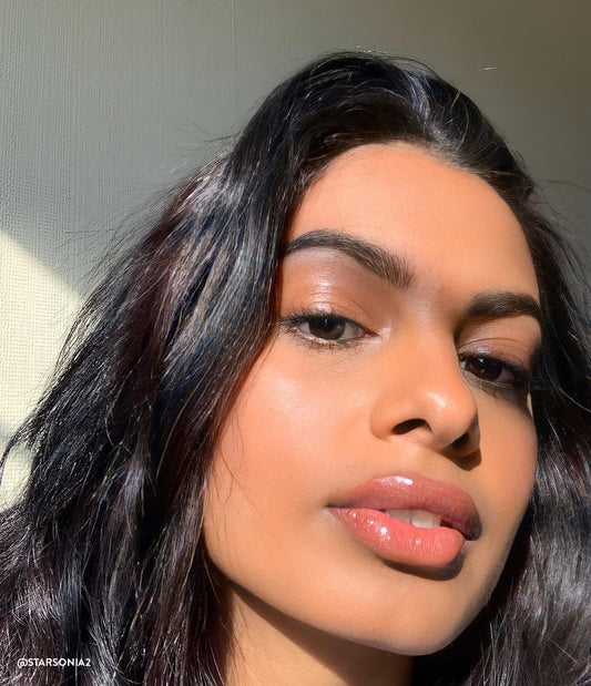 Woman wearing Honest Company Beauty products