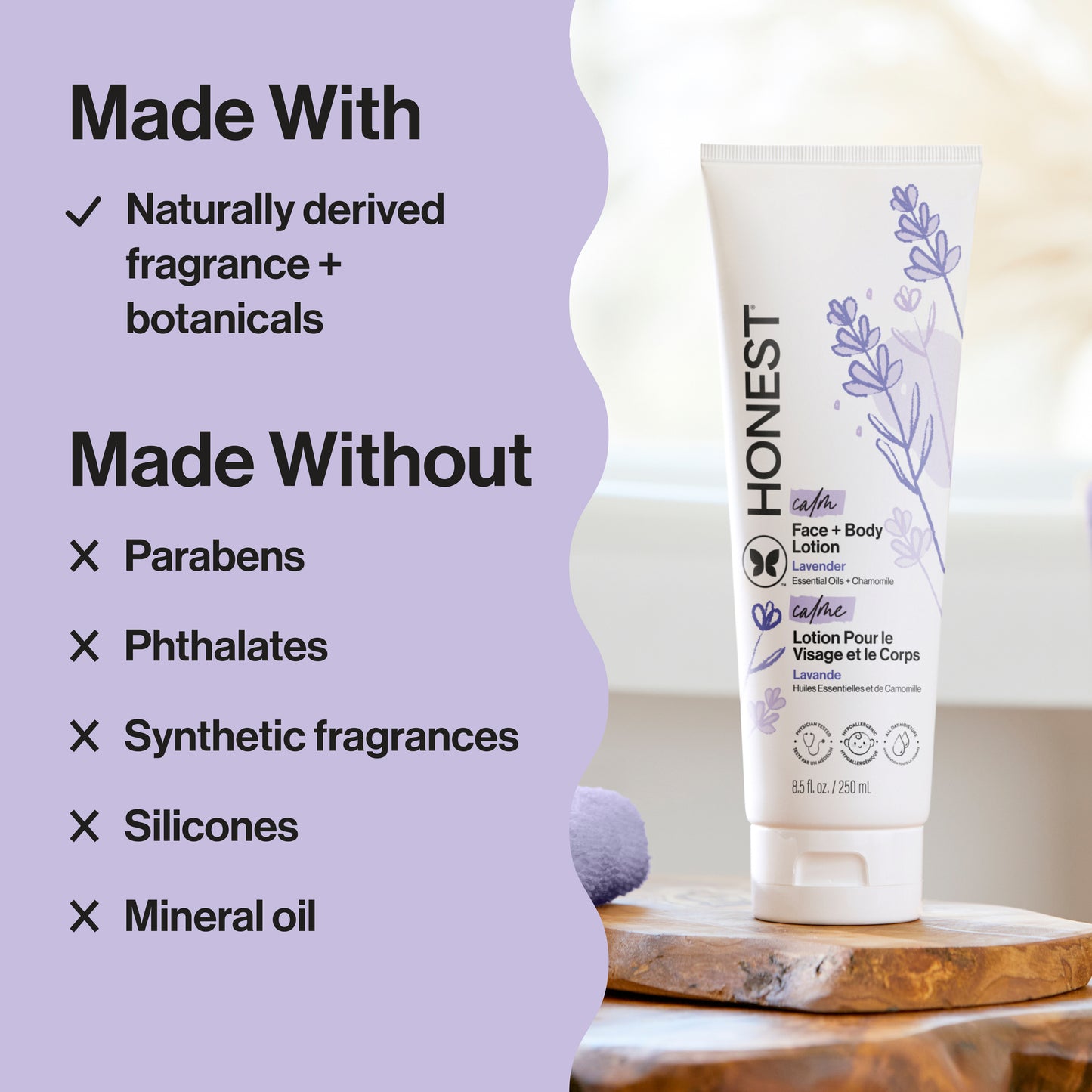 Honest Company face and body lotion with lavender scent on a wooden board against a light purple background.