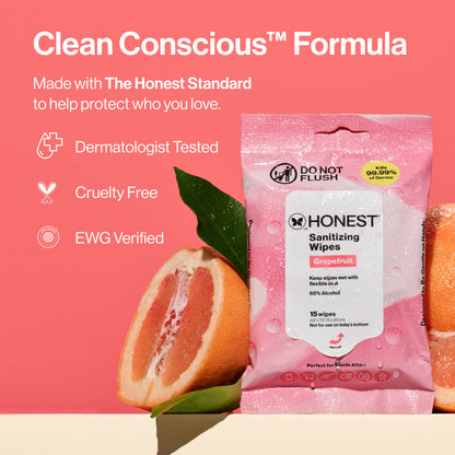 A pink packet of Honest Sanitizing Wipes labeled Grapefruit, shown on a coral-pink background with grapefruit slices and leaves. Large text reads 'Clean Conscious Formula' and lists Dermatologist Tested, Cruelty Free, and EWG Verified.