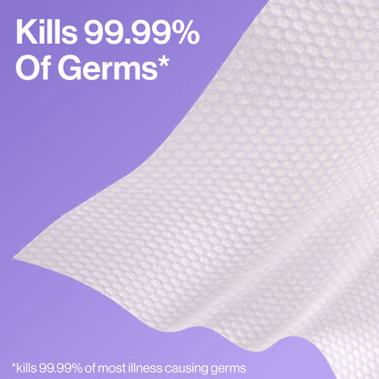 A white textured cleaning cloth or towel with a wavy fold, shown against a purple background with promotional text stating 'Kills 99.99% Of Germs'.